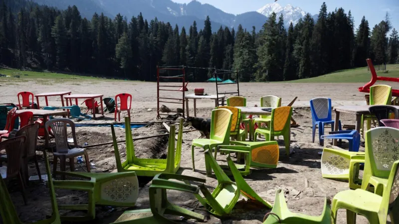 Chairs and tables are seen scattered at the site of the Pahalgam attack