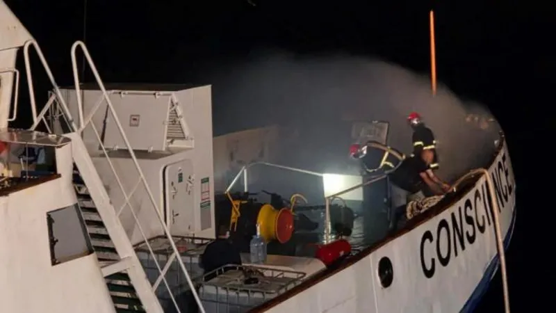 Firefighters try to extinguish the blaze on board the Conscience