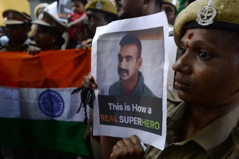 Indian security forces with photos of captured pilot Abhinandan Varthaman at a prayer event, March 2019